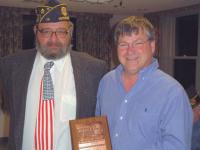 (L to R) Legion Post #14 Trustee and Selection Committee member Mike Sullivan presents the award to Mel. The event was held on Thursday evening, March 9th, 2006.