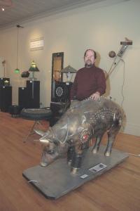 David Martin stands by his creation “CyBOARg”. This along with his other sculptures are now showing at the “UnEarth” exhibit at the Brandon Artists Guild on Center St.  in Brandon through April 28th.