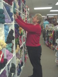 Jean Clark sorts yarn at Knits and Bolts in New Haven.