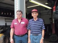 Francis Dupoise and his son Steve share a moment at Steve’s County Tire located on Seymour Street in Middlebury.