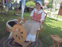 At the first annual French Heritage Day, Grace Foshay age 14, of Bridport spins alpaca yarn from her family farm.