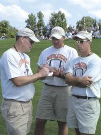 Middlebury Tigers Varsity Coaching Staff  compares notes during 3 team scrimmage held on Saturday August 26th between the Tigers, Spaulding High and Rice Memorial High Schools.  The Tigers looked sharp and according to Head Coach Pete Brakeley (L.)
showed some of the aggressiveness that the coaches are looking for this time of year.