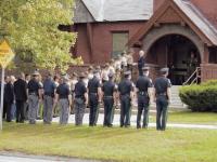 Members of The Vermont State Police, Addison County Sheriff’s Department and Middlebury Police Department snap to attention outside the Middlebury United Methodist Church on Thursday morning 9-7-06 as they honor the late Wayne Heath. Heath served the state as a career state trooper and most recently as a Addison County Side Judge. He was preparing to run for a 4th term on the bench.