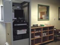 State-of-the-art processing room, with photographic equipment for mug shots.  Holding cells are also in this secure area.