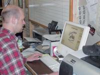 Earle Provin at his computer at the GRAPH-X office on Exchange St. in Middlebury.