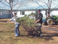 FFA members Amanda Corey and Adam Breen help remove unwanted shrubs in the landscape garden at Helen Porter Rehabilitaion Building 