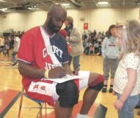 Sayeed Abdul-Muntaqim (a.k.a. Rainbow) autographs a program for a young fan during halftime of The Court Jesters Comedy Basketball benefit game on 3-16-07 at MUHS.
The Jesters and Police Explorers enjoyed a great game. The fans got to sing, dance and interact with all the players. The Jesters have played similar games all over the world. For more info see www.cjesters.com.