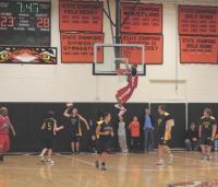 Police Explorer Mike Kemp #15, inbounds to #5 Shane Morin, while #31 Leslie Davignon, #23 Kevin Emilio and #12 Seth Fisher prepare to move up court. But wait! Isn’t that a Court Jester still hanging around after making a “Monster Mash”? The game took place on 3-16-07 as a fund raiser for the Explorers and looked like a sell-out!