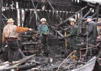 Vermont Field Sports store owner Dick Phillips points out information to fire investigators at the scene of a fire that destroyed his store on Thursday night April 26th. The cause of the fire is still undetermined and is under investigation.