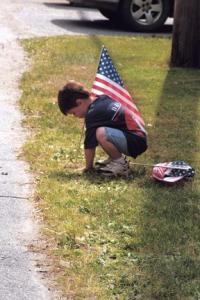 This young fellow stake’s out his spot along the parade route before the Bristol
4th of July Parade. The rain held off and the annual event was a spectacular success.