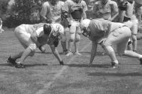 Middlebury’s Robbie Harrison (right) works out with the linemen in 90 degree temps on Friday moring in Plymouth NH.