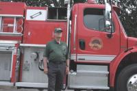 Ryegate Vermont Fire Chief Gene Perkins stands next to a METALFAB fire engine during an exhibition of fire and safety equipment at Middlebury College.  The Chief is also a METALFAB factory rep for K & T Fire Equipment Sales and Service (Fire Apparatus Sales) in the State of Maine and Vermont.   A score of exhibitors attended the 2007 Vermont State Firefighters Convention held in Middlebury and hosted by The Addison County Firefighters Association.  Exhibitors were impressed with the hospitality offered by Middlebury College and the Middlebury Community. 