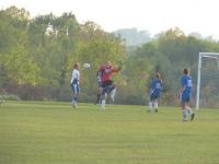Meghan Scott-Tisbert, goal keeper for Vergennes comes out and attacks a shot from the Raiders.