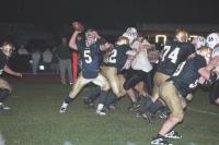 Essex quarterback Max Librizi looks for an open receiver while under pressure from Middlebury Tigers 53 Eric Fifield, 54 Tyler McNally and 86 Nate Lawson. Middlebury went to 5 and 0 on the year with a 35 to 21 win at Essex.