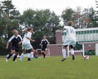 Middlebury’s Kelly Mandigo advances the ball upfield against two Rice defenders.