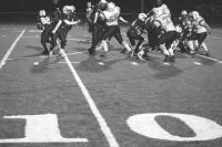 Tiger Jonathan Wright #55 fights off a block to go after BHS ball carrier Justin Ploesser #82 while Tigers #77 senior Travis Karpak moves in - Tigers won at Burlington 35-13.