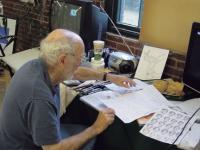 Bill Holway resident artist at Kennedy Brothers shown working on his art.