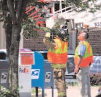 Middlebury Volunteer
Fire Department Chief Rick
Cole and Crewmembers
prepare to blast a suspicious
package with their high
powered water cannon after
it was discovered by the
town's parking control
officer under a drop box in
front of the Middlebury Post
Office at about 12:30 p.m.
on Friday June 15th, 2007.
Middlebury Police were
notified and Middlebury
Police Chief Tom Hanley
ordered the area around the
post office and upper Main
Street cordoned off and
buildings in the area evacuated according to bomb threat protocol.
The state's bomb squad was notified. After consulting with the bomb squad,
local firefighters moved the box deeper into the post office property near some large
trees where it was destroyed with a blast from the water cannon mounted on the
fire departments big ladder truck. By extending the ladder, firefighters were able
to safely maneuver the large high pressure nozzle over the box and destroy it.
Police later determined that the box and its contents did not pose a threat and that
the entire incident was a hoax. If apprehended the perpetrator could face local,
state and federal prosecution.