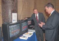 John Kneuer, right, Administrator of the National Telecommunications and Information Administration (NTIA) and Assistant Secretary, U.S. Department of Commerce, learns about the digital-to-analog converter box developed by LG Electronics. Demonstrating the LG device, which has been certified for the NTIA's converter box program, is LG Electronics USA Vice President John I. Taylor, left.