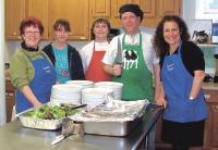 Jutta Miska (far left) stands with teen
members of ACT and other adult volunteers at a recent community supper hosted by ACT at the Middlebury Congergational Church.