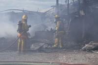    Salisbury firefighters prepare to extinguish the last remnants of a barn fire at The Nop Brothers & Sons cattle barn.