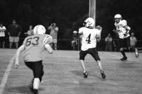 O.V.’s Zakk Williams #4 looks down field for a target as Tigers #63 Troy Audet moves in. O.V.’s #22 Parker Howland swings wide as the safety valve on the play.