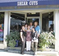 The full crew of professionals from Shear Cuts peaks out from underneath the awning of their new location on Main Street in Vergennes. Front: Melanie Chaput, Jill Bourgeois and Sierra Rousseau. Back: Christine Dwy, Connie Gendreau and Hillary Devine.
