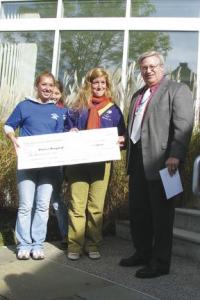 Presenting a check for $3,000.00 to Porter Hospital President James L. Daily are VUHS Seniors Sarah Bissonette and Kate Housekeeper.