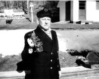 The WWII Navy Veteran displays a sextant as he stands outside his McDonough Drive home.