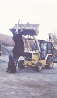 While it is not the normal use for his equipment, Frances stands proudly next to a 629 lb. Moose he took on a hunt in 1991. The freezer was sure full that winter!