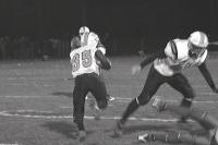 Middlebury halfback Ryan Foley finds some running room off a big block from teammate Riley Billings during Division II play-off game at Colchester on Friday night November 6th 2009.  The Tigers spotted the Lakers 12-0 in the first half and were unable to close the gap in the second half.  The Lakers via the win over Middlebury moved on to the D-II State Championship after holding off the Tigers strong second half come-back-bid 12-7.