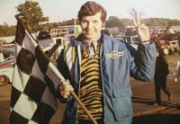 Beverly Stearns proudly shows off some of her racing flags from her races in the 1970’s at Catamount and Thunder Road.