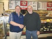 Left to right: Greg Wry former owner of Greg’s Market congratulates the new owner Bart Litvin.