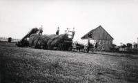 Taken just a couple of years before the farm switched to tractors, Helen’s father and helpers bring in hay one hot July day in 1932.