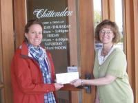 Michelle Shambo (right) presents a check for $1,000 to Nancy Rosenberg representing a sponsorship donation from the Chittenden Bank to the Porter Medical Center Auxiliary for the annual