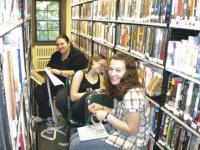 Morgan Kimball and Amanda Delphia work with others at the Bixby Library.