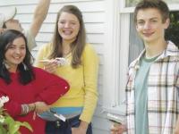 Sophomores Daisy Alexander, Hannah Curler and JJ La Fountain stop work on painting the home of a local individual in Ferrisburgh on Thursday, May 19th.