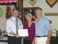 Lions Club President Dave Nourse presents a $5,000 check to Mickey and Carol Heinicken, who are leading the effort to raise a million dollars over five years for the Middlebury Voluntary Ambulance Association. The is the first of five checks to support their pledge of $25,000.