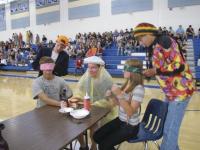 Advisor Karl Steen waits with anticipation to be fed an ice cream sundae by blindfolded students as part of the Homecoming Spirit Activities.