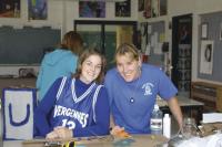 VUHS Senior Shelby Sheehan and Senior Class Advisor Sandy Chicoine prove that blue, white, glue, cardboard and spirit can produce great floats and great memories.