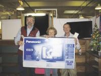 Shirley Andrews accumulated over 10-million points for purchases made and is seen above with her beautiful brand new Panasonic Viera 32-inch flat screen television as store Win Grant and  retail promotional consultant Graeme Bulloch look on.