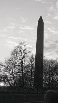 With the sun setting on the first day of the trip, the students pause to admire the beauty of the Washington Monument, a treasure from the past, as a steady stream of passenger airplanes pass over in quick succession.