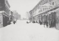Main Street in Middlebury was snowed under in the biggest snowstorm ever recorded in Vermont, the Blizzard of 1888.  In this 1888 photo the snow is still blowing, but in the distance you can just about make out the triangle where South St. and South Main split. The sign on the right saying ‘China Hall’ was at the head of Mill St., going down to Frog Hollow.