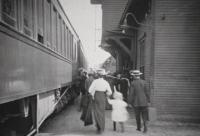 Passengers and trains at the Vergennes Train Station, date unknown. The station still stands today and this photograph was taken at what is now the rear of the building, looking down the tracks toward Middlebury.
