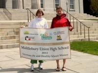 MUHS Assistant Principal Cathy Dieman and Prevention Specialist Brooke Jette display the banner the school received as the recipient of the Gold Level 2011 Fit and Healthy School