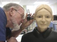 Dennis Maloney examining the ear of one of the training mannequins in the Task Trainer Room at the Clinical Simulation Lab. 