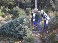 Erik, Rich and Paige Stolen finding the perfect tree at Zeno's Tree Farm.