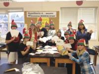 From left to right: MUMS 8th graders from Team Mosaic L J. Hounchell, A. Sheldrick, K. Smith, N. Bauchamp, K. Charbonneau, C. Balparda, Teacher Shannon Warden, N. McWilliams, D. Gero, S. Amory, S. Snide, and B. Lepri gathered to make cards, write letters and send holiday greetings and thanks to over 170 Vermont Green Mountain Boys stationed overseas in Afghanistan.