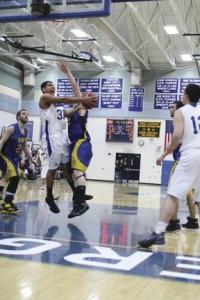 Commodore Junior Forward Stanley Salley drives to the lane around the defender in a recent game against Lamoille.