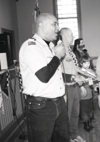 Cub master Gary Rusell is the enthusiastic announcer for the Pinewood Derby.